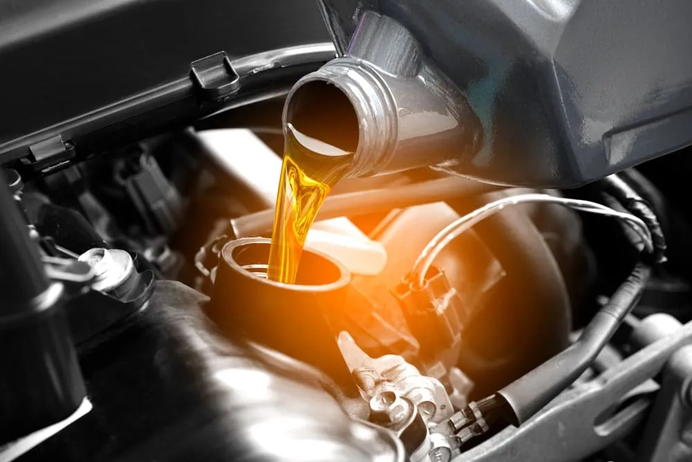 A car engine being filled with fuel.